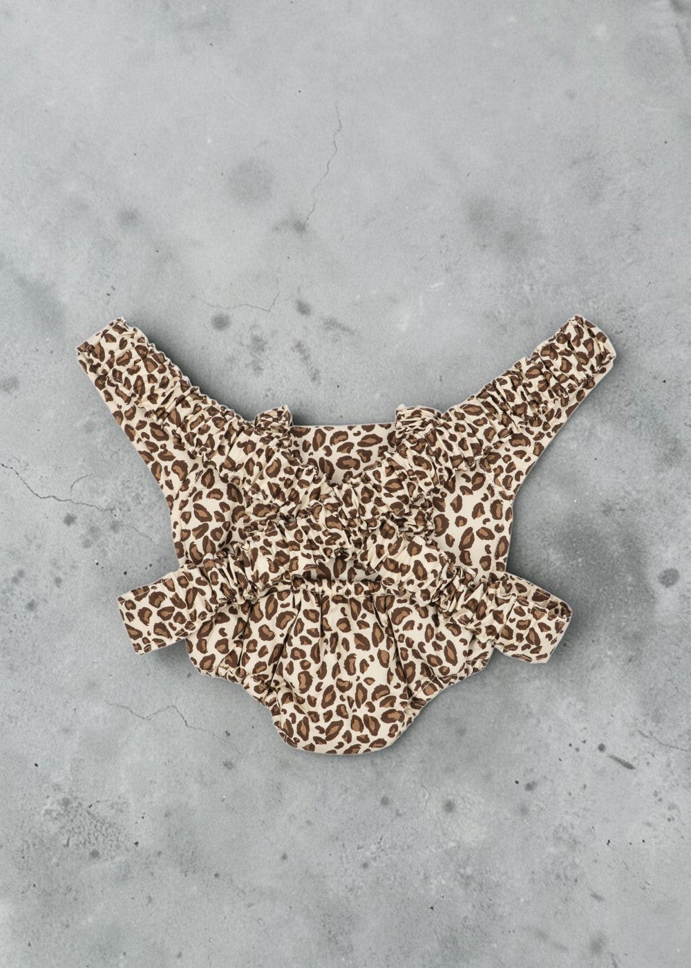 Playroom Collective Konges Sloejd doll carrier in cream and brown leopard print with elastic straps and cherry detail