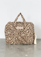 Playroom Collective Konges Sloejd leopard print cotton doll diaper bag with top handles and crossbody strap.