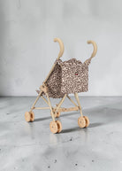 Playroom Collective Konges Sloejd doll stroller in leopard print with sage frame and cherry detail
