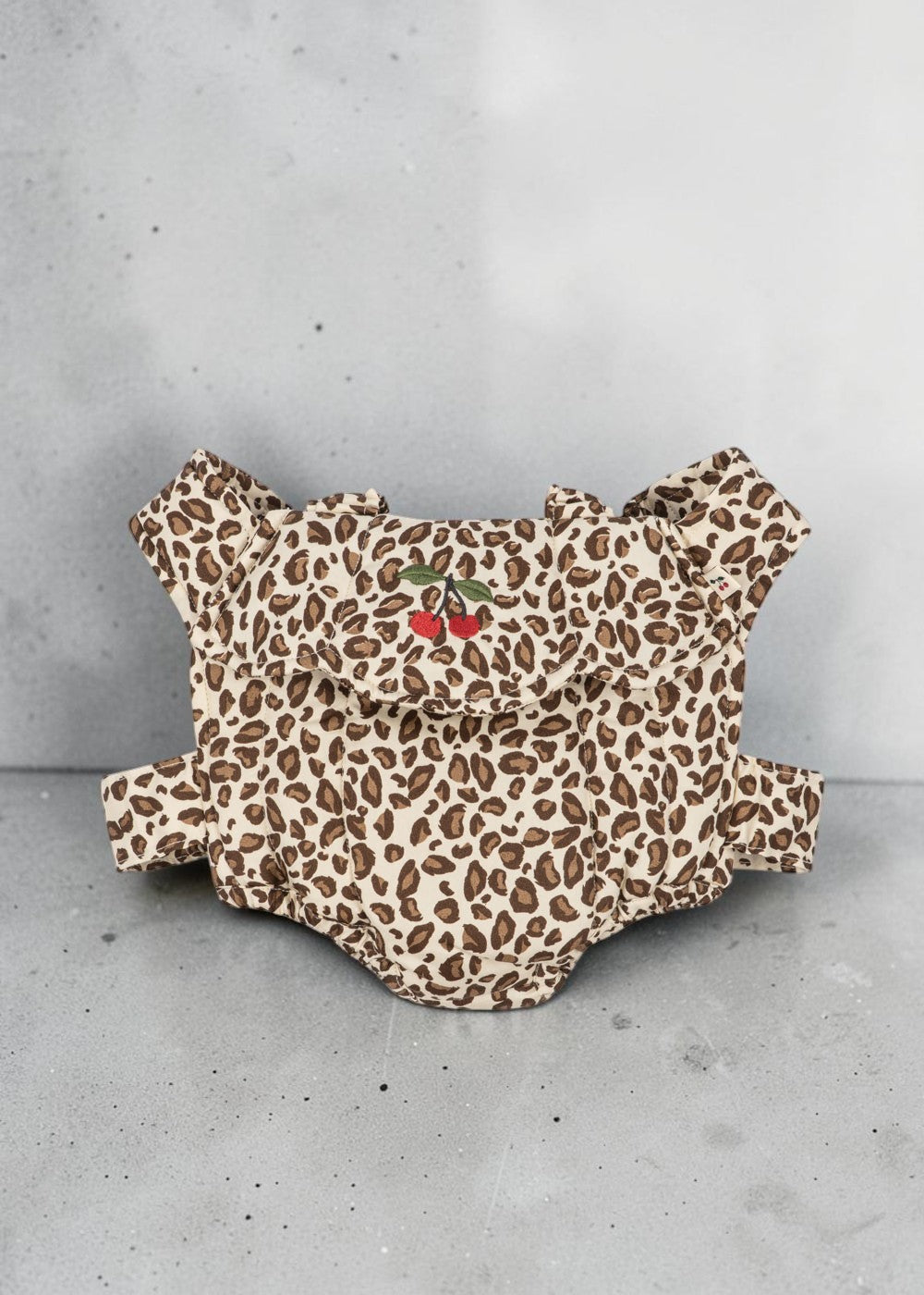 Playroom Collective Konges Sloejd leopard print doll carrier in cream and brown cotton with embroidered cherry detail.