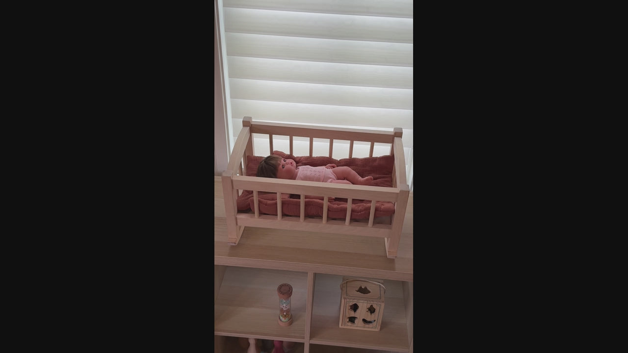 Baby doll cradle rocking back and forth