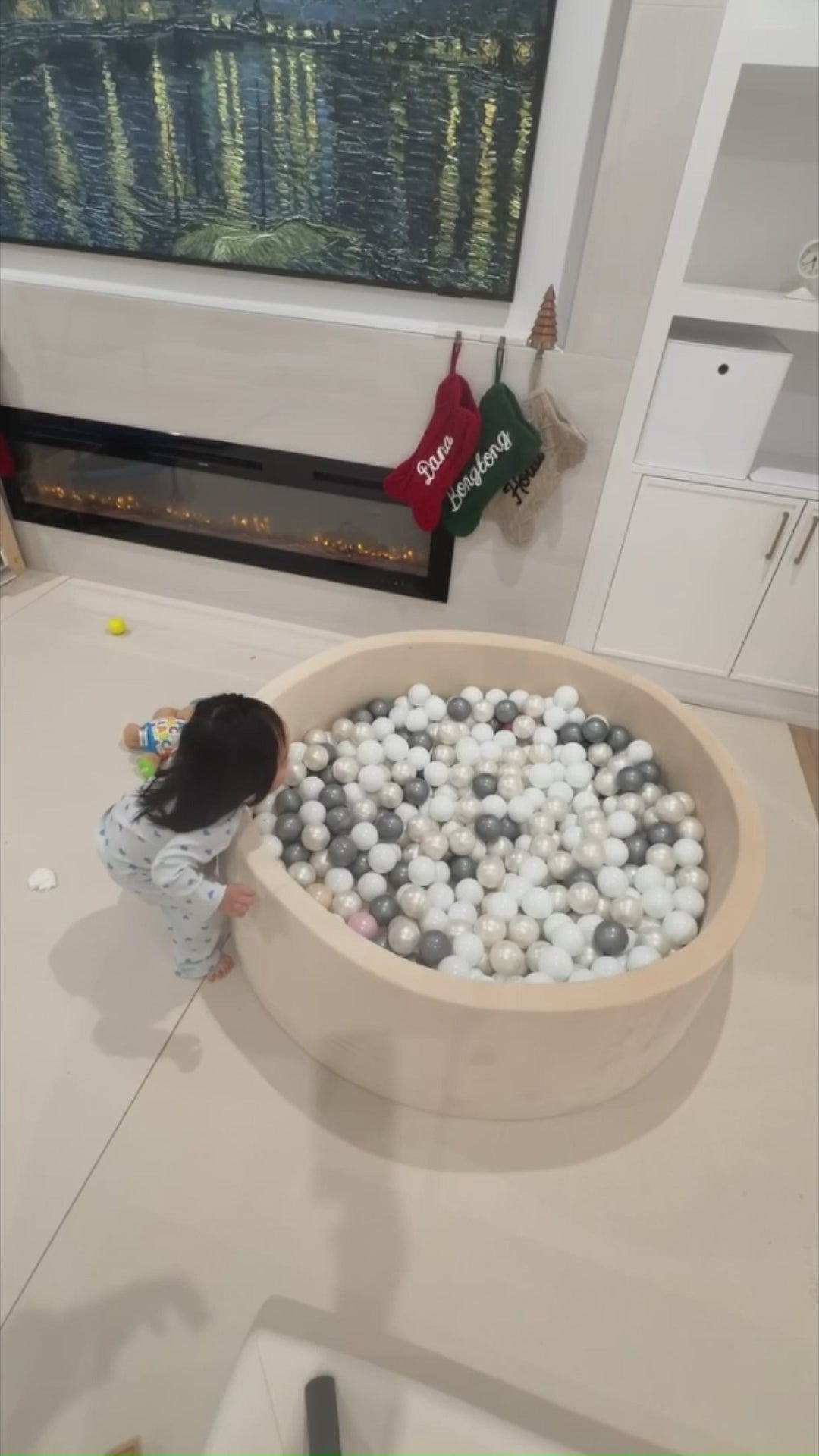Child jumping into ball pit