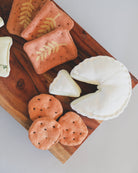 Gourmet play food charcuterie collection featuring hand-embroidered herb cheese and silk screen printed crackers